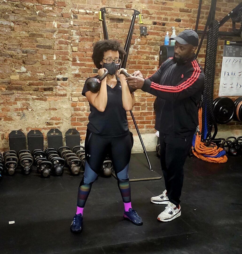 A man and woman are working out in the gym.