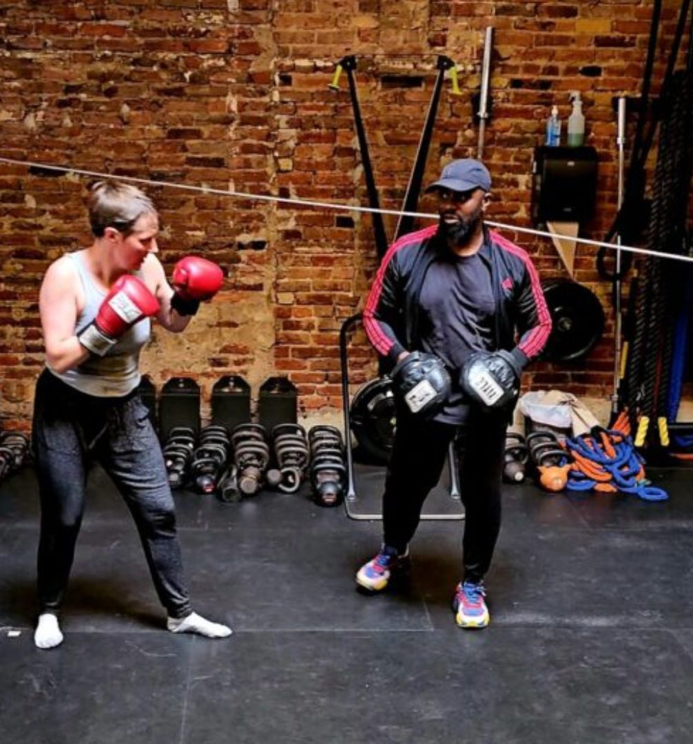 Two people are boxing in a gym.